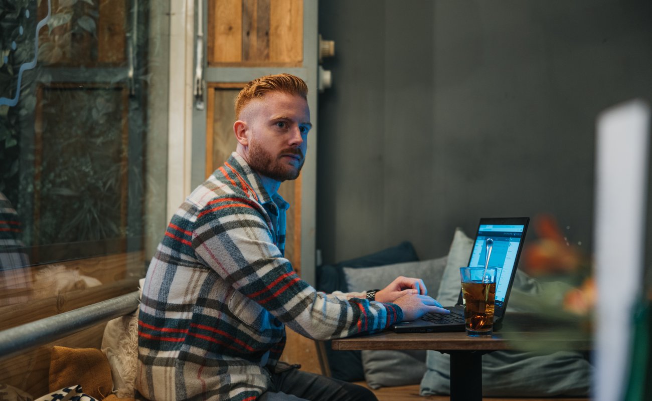 MAn behind laptop