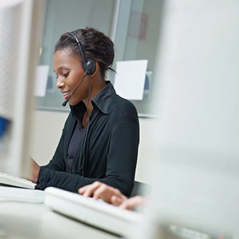graphicstock-female-african-american-customer-service-representative-talking-on-the-phone-and-typing-on-pc-horizontal-shape-side-view-copy-space_r2vyWO9DZ (1).jpg