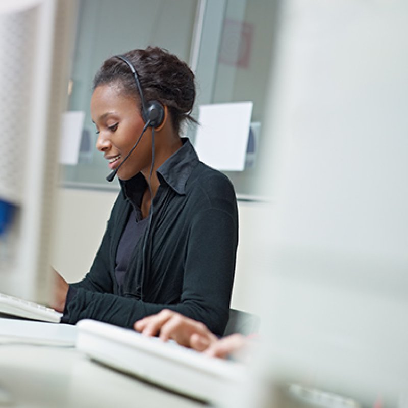 graphicstock-female-african-american-customer-service-representative-talking-on-the-phone-and-typing-on-pc-horizontal-shape-side-view-copy-space_r2vyWO9DZ (1).jpg