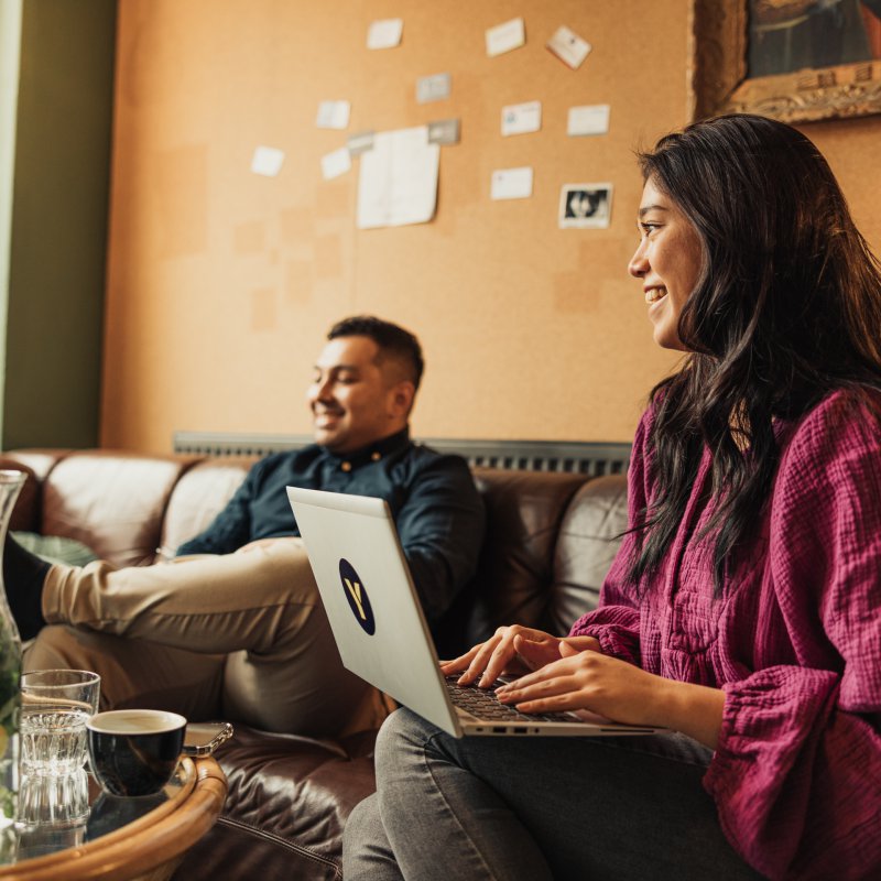 Boy and girl on couch with laptop