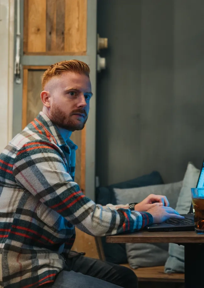 MAn behind laptop